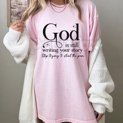 "God Is Still Writing Your Story" Christian T-Shirt â Inspirational Faith Graphic Tee, Premium 100% Cotton Grace Top, Soft Lived-In Heavyweight Storyteller Shirt, Made in USA