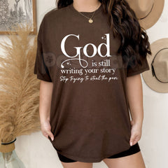 "God Is Still Writing Your Story" Christian T-Shirt â Inspirational Faith Graphic Tee, Premium 100% Cotton Grace Top, Soft Lived-In Heavyweight Storyteller Shirt, Made in USA